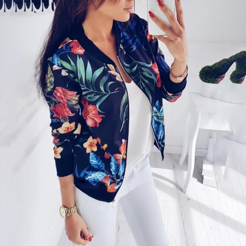 Women's botanical print zip-up jacket with colorful floral and leaf design on black background