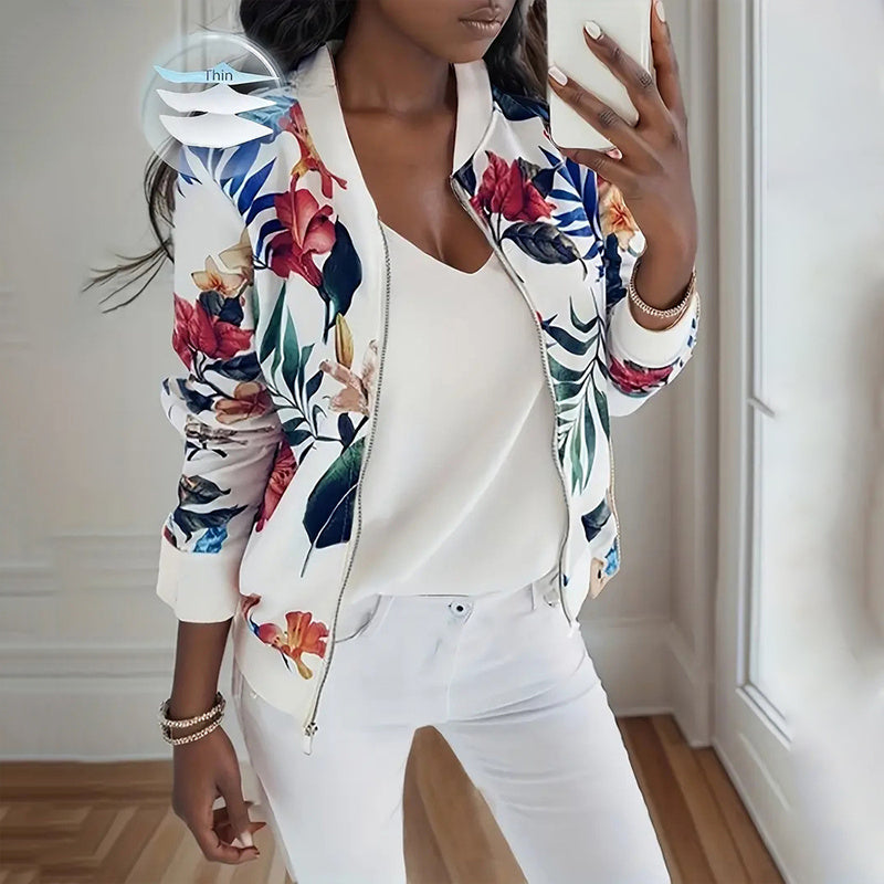 Woman wearing a women's botanical print zip-up jacket with colorful floral design and white zipper