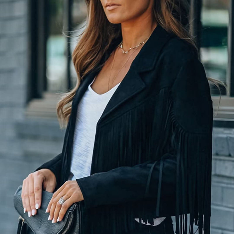 Stylish black women's faux suede fringe jacket worn over white top with a black clutch purse