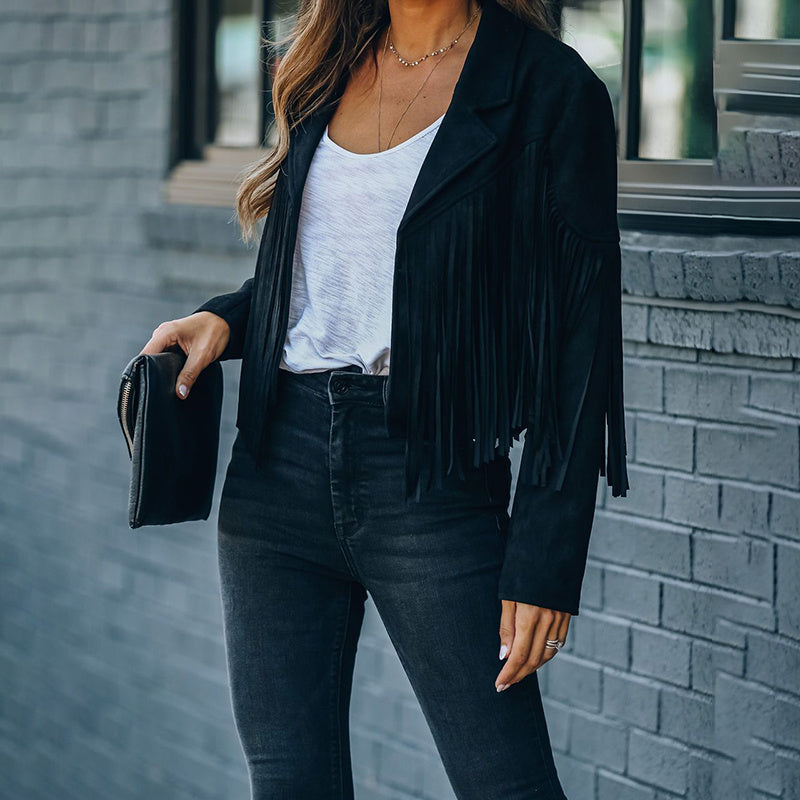 Black women's faux suede fringe jacket styled with white top and black jeans for a casual look