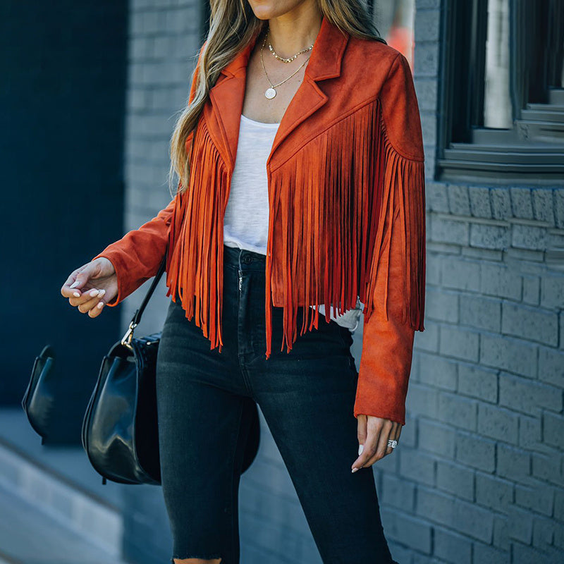 Stylish women's faux suede fringe jacket in burnt orange worn with black jeans and white top