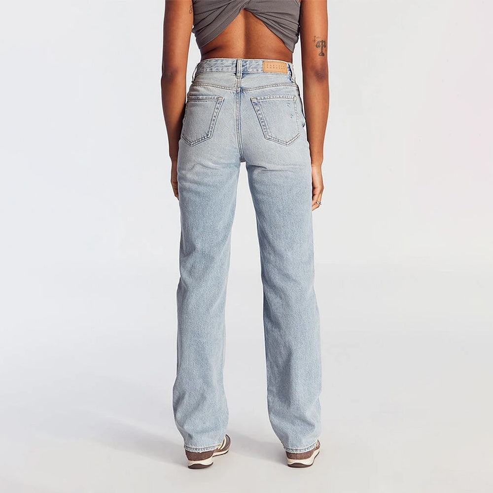Back view of women's high-waist wide leg jeans in light blue denim with pockets and belt loops