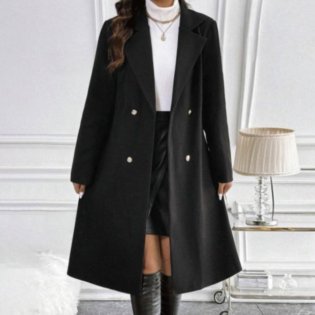 Black women's long sleeve knit jacket styled under a black double-breasted coat with gold buttons