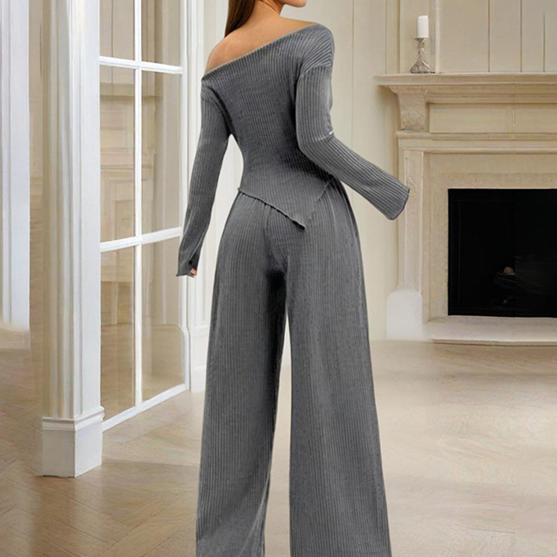 Woman wearing a gray ribbed women's off-shoulder lounge set with long sleeves and wide-leg pants indoors