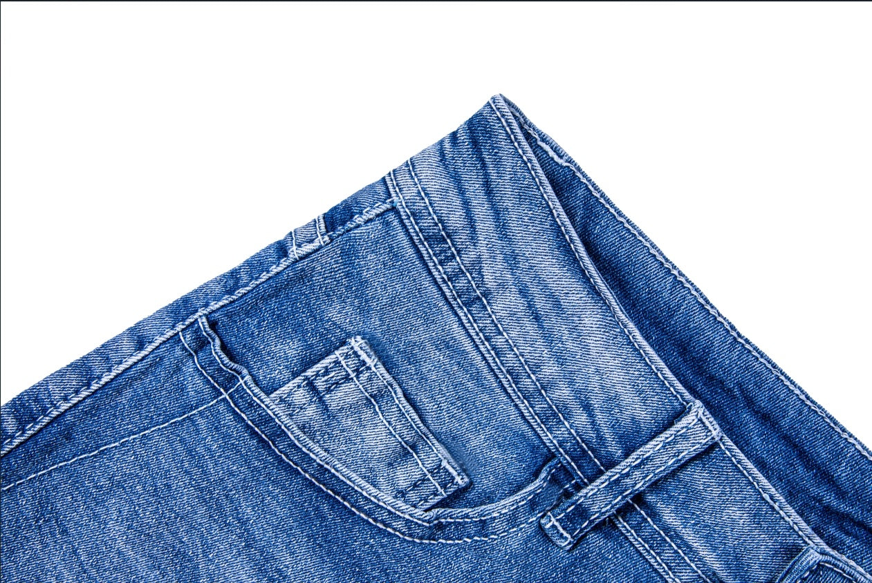 Close-up of blue womens ripped jean shorts pocket and stitching detail
