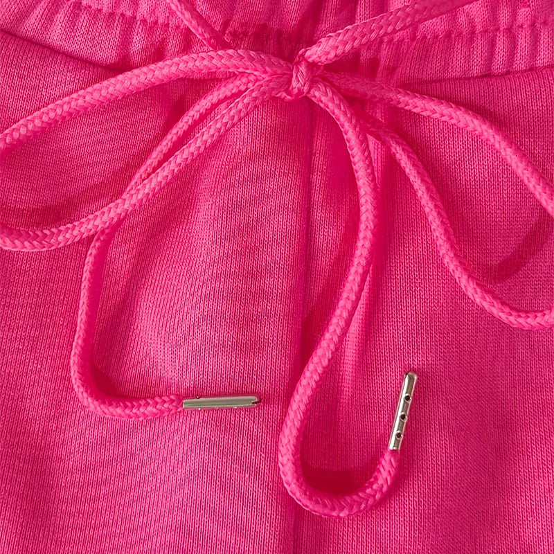 Close-up of pink women's straight leg pants drawstring with metal tips