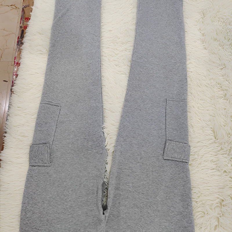 Gray women's straight leg pants made of soft fabric with side pockets laid flat on white surface