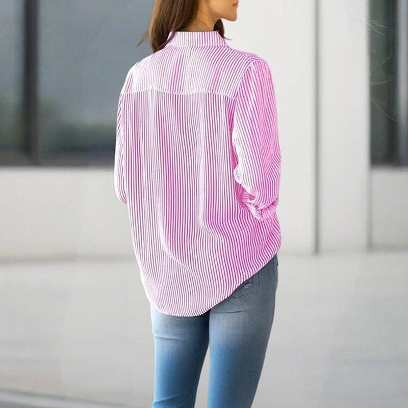 Back view of a woman wearing a pink and white women's striped button-up shirt paired with blue jeans