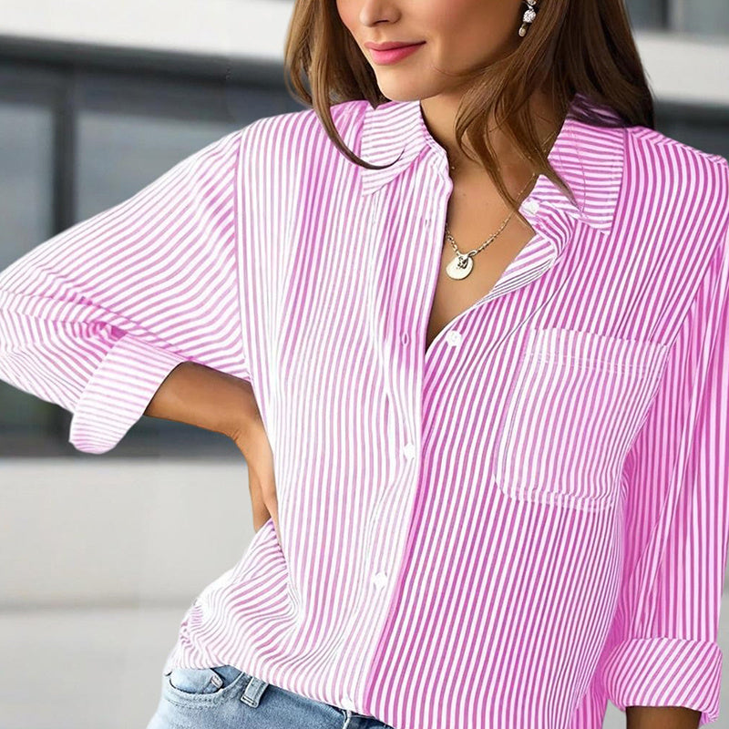 Woman wearing women's striped button-up shirt in pink and white with front pocket and rolled sleeves