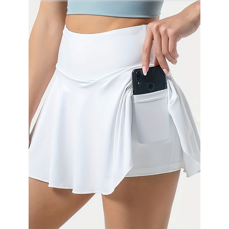 White women's tennis skirt with pockets holding a smartphone with high waistband design
