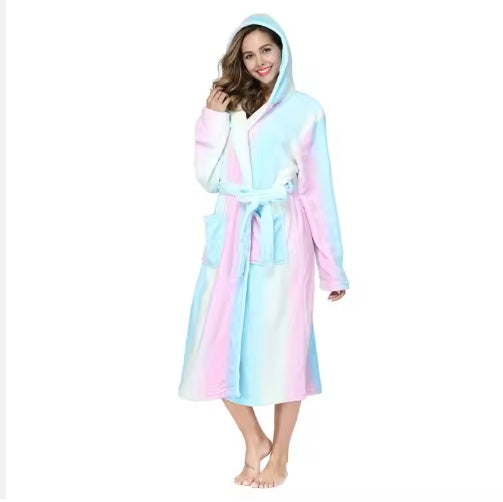 Woman wearing pastel pink and blue hooded women's winter flannel bathrobe with pockets and belt